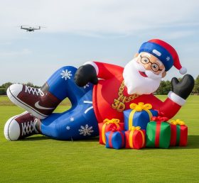 C1-515 Papai Noel inflável estilo hip-hop deitado ao lado dos presentes
